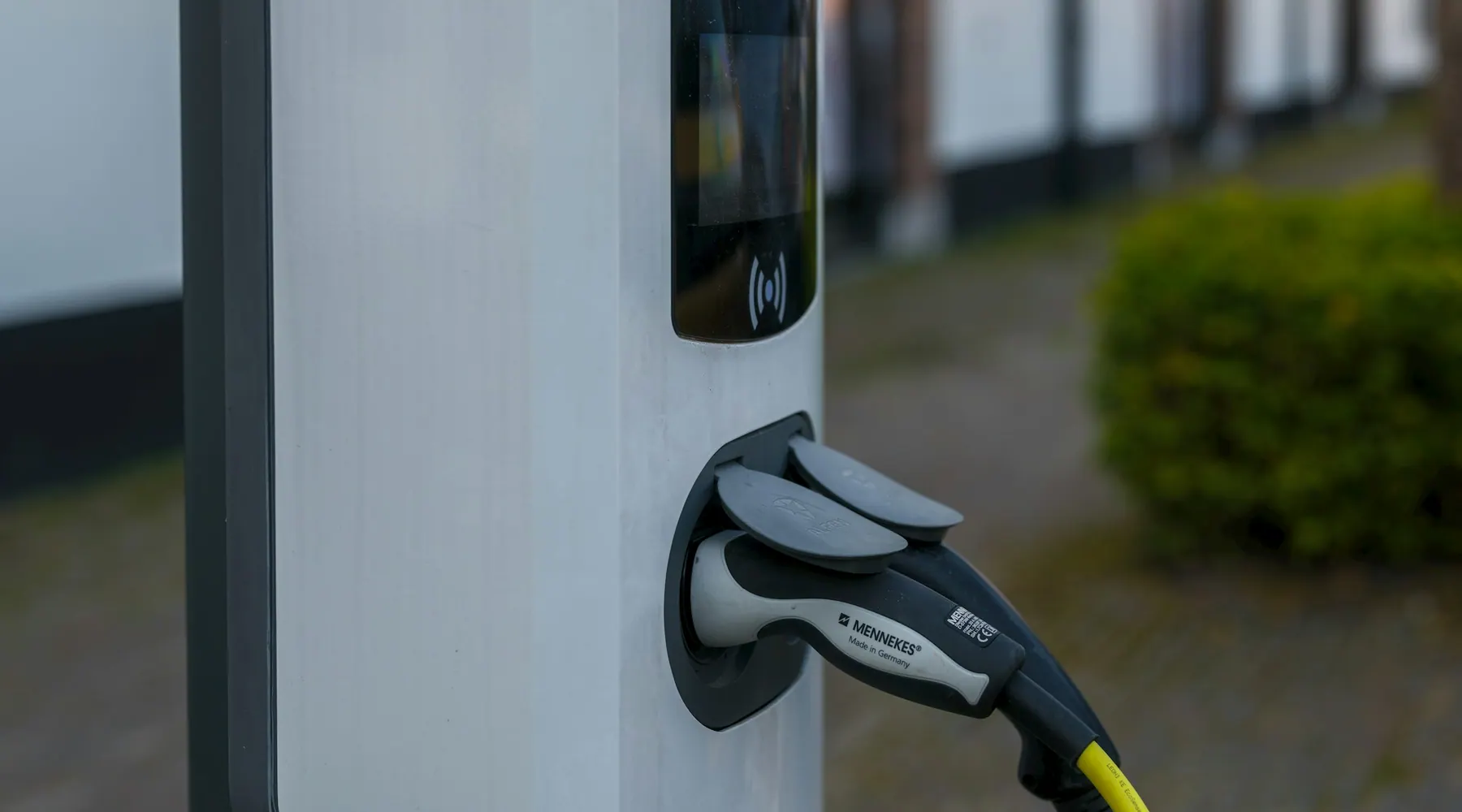 An electric vehicle charger, plugged in